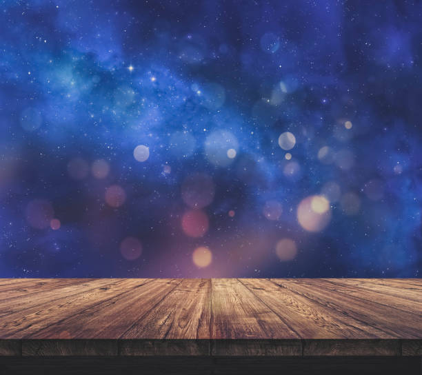 Wood table top with blurred light colourful bokeh abstract background