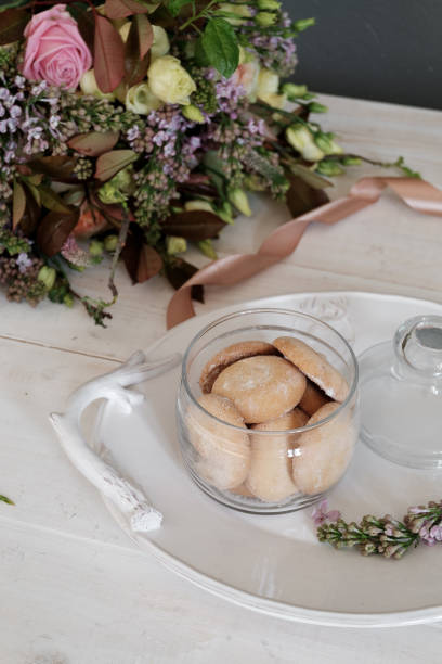 istock A beautiful cookie on a platter. Flowers in the background 939017828
