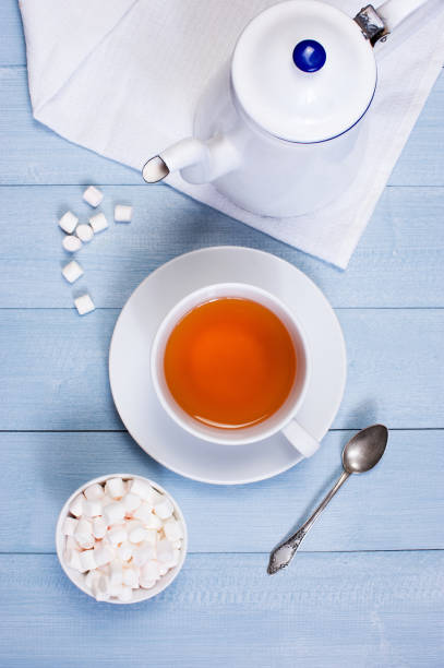 istock The cup of tea and white kettle on the table 939019002