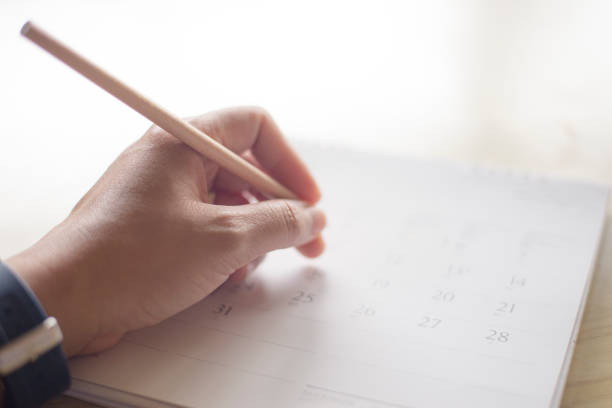istock close up hand writing in calendar plan concept. 939019056
