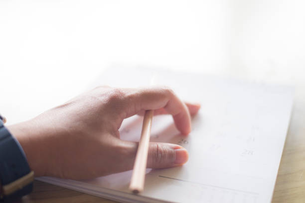 istock close up hand writing in calendar plan concept. 939019106