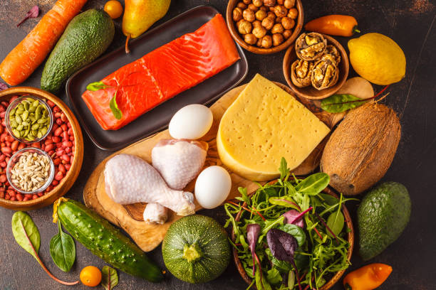 Keto (ketogenic) diet concept. Balanced low-carb food background. High protein food. Vegetables, fish, meat, cheese, nuts on a dark background. Keto diet concept. Balanced low-carb food background. Vegetables, fish, meat, cheese, nuts on a dark background. paleo diet photos stock pictures, royalty-free photos & images