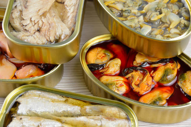 ready to eat Assortment of cans of canned with different types of fish and seafood collection clam stock pictures, royalty-free photos & images