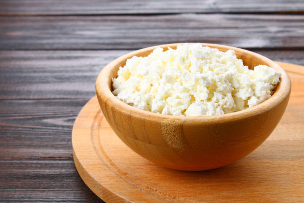 istock Home cottage cheese in a bowl on a wooden table. 939019884