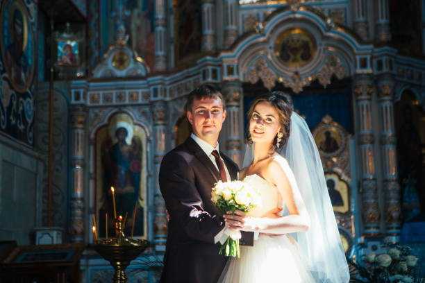 istock young couple groom and bride on church background 939019936