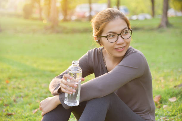 istock Asian female is resting and drinking water. 939022794