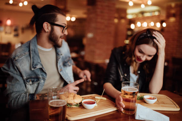 istock Young man telling funny story to his girlfriend 939023016
