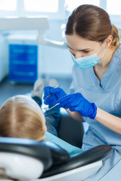 istock Charming female dentist carrying out oral cavity checkup 939023512