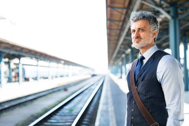 istock Mature businessman on a train station. 939028108