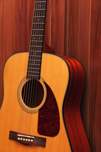 istock Acoustic classical guitar on a wooden background 939028134