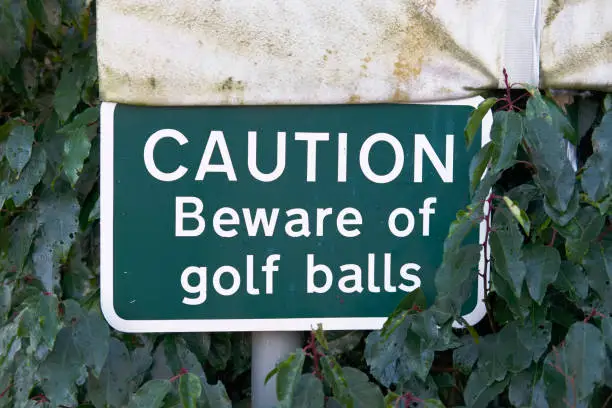 Beware Golf Balls Sign on Club Course Warning to the Public in countryside park