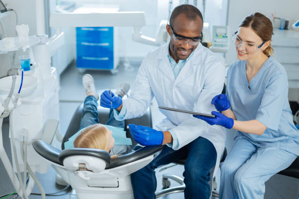 istock Pleasant nurse showing important message to dentist 939030554