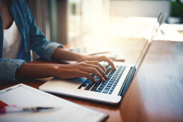 Getting down to work Closeup shot of an unrecognizable woman using a laptop while working from home keypad stock pictures, royalty-free photos & images