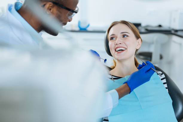 istock Cheerful patient and dentist joking during checkup 939034966