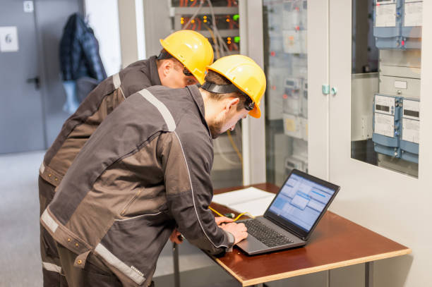 istock Two maintenance engineers inspect relay protection system with laptop comp 939039078