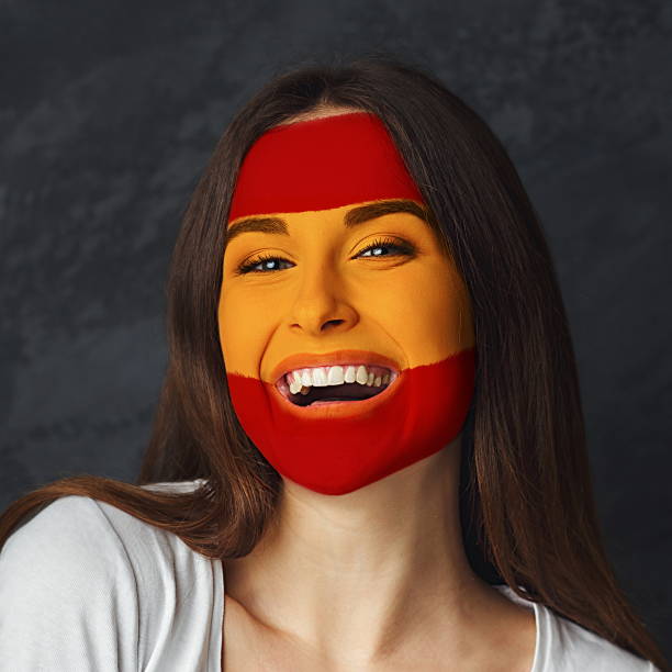 istock Young woman with Spain flag painted on her face 939039588