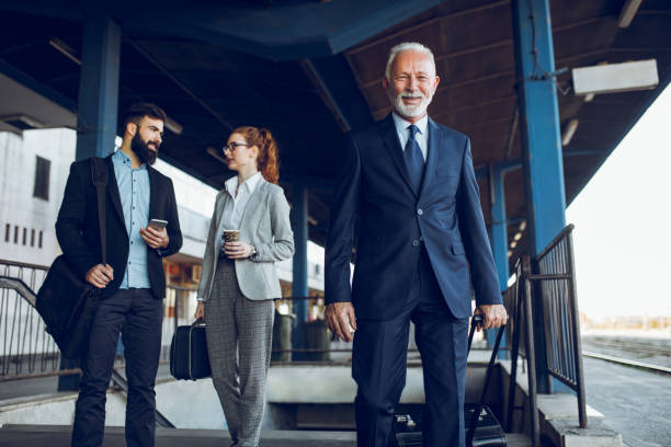 istock Business people with luggage at train station 939042682