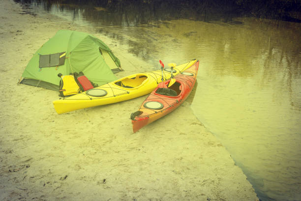 istock Water trip on kayaks. Camp on the river bank. 939042934