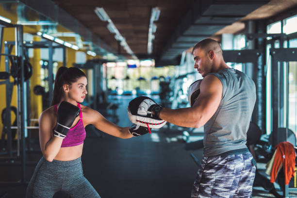 istock Female boxer sparring with her trainer 939042954