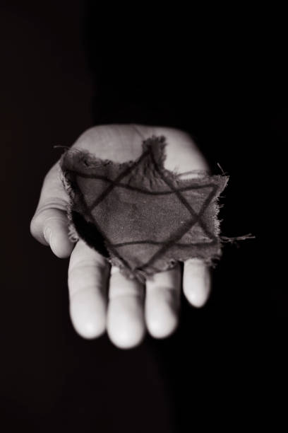 istock man with a ragged Jewish badge 939043232