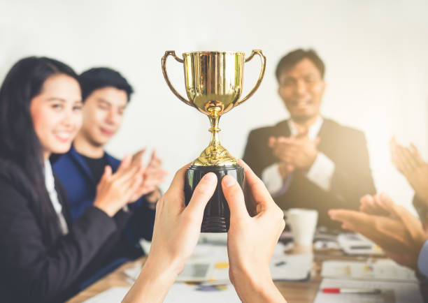 businessman show thumbs up with trophy, reward, winner, champion and successful for business - thumbs up business occupation competition imagens e fotografias de stock