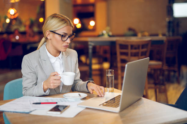 istock Businesswoman working on laptop in cafe 939043354