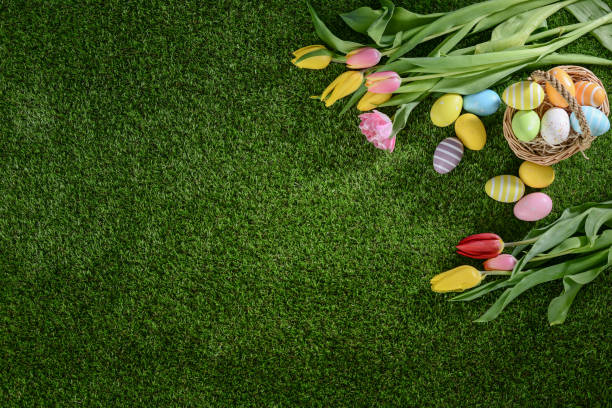 istock above top view of multi colored painted easter eggs with springtime tulip bouquet flowers on green grass 939043568