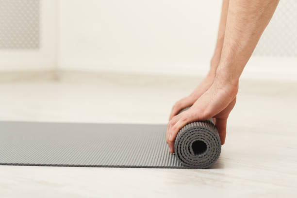 istock Rolling up fitness mat for exercise copy space 939043938