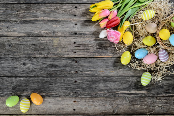 istock above top view of multi colored painted easter eggs with springtime tulip bouquet flowers on a old wood plank 939046318