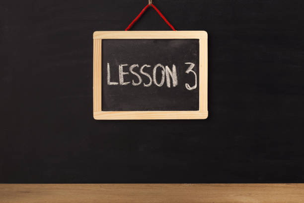 istock Word lesson 3 written on miniature chalkboard 939046910
