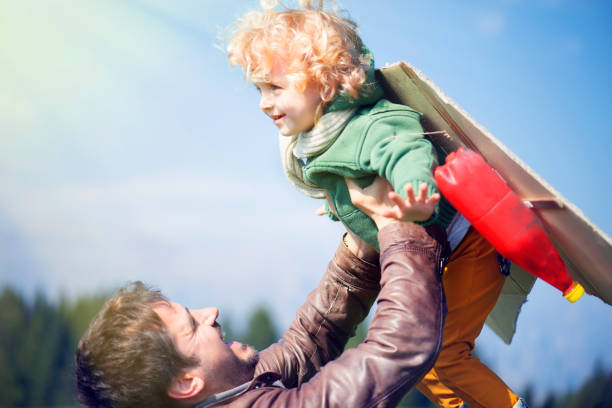 istock Father and Child Imitating Flying 939047058