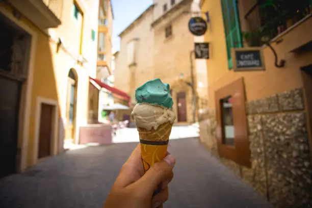 Ice Cream cone in a hand in the street of Palma de Mallorca, Spain