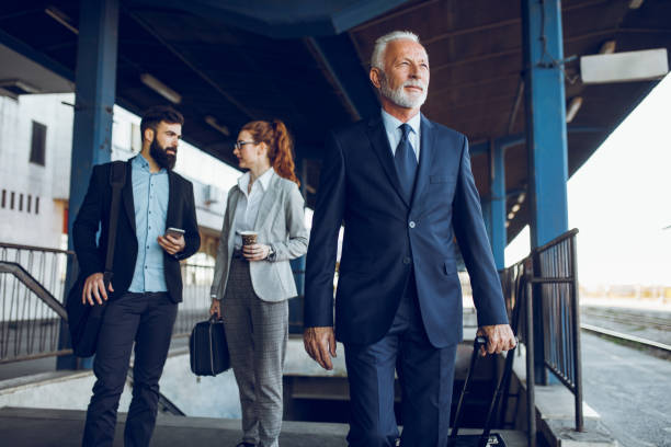 istock Business people with luggage at train station 939051694