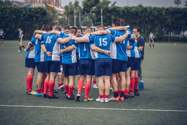 Rugby players huddling Rugby players huddling during time out. scrum stock pictures, royalty-free photos & images