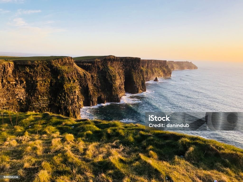 Cliffs of Moher, Co. Clare, Ireland Sea cliffs at the southwest edge of the Burren region of Ireland. Waves break against the cliffs at sunset Cliffs of Moher Stock Photo