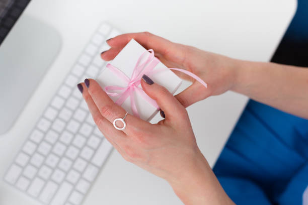 istock Woman holding a gift box 939055302