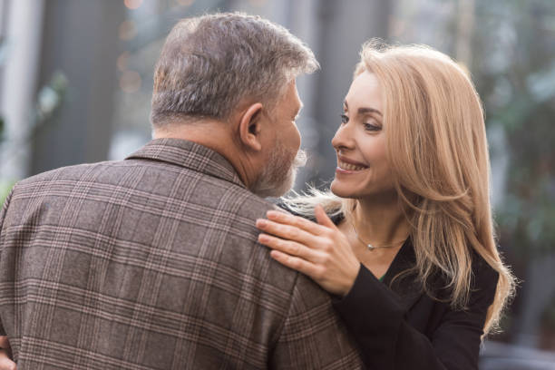 istock smiling couple hugging each other on romantic date 939058296