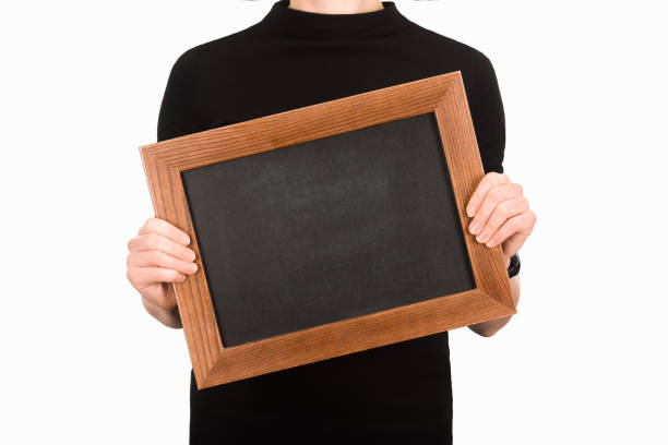 istock Partial view of woman holding empty blackboard isolated on white 939061834
