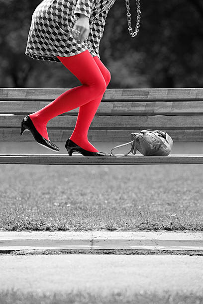 Woman on bench with red tights  isolated colour stock pictures, royalty-free photos & images