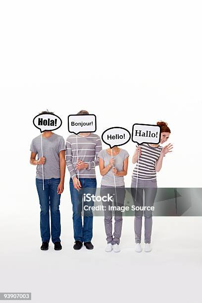 People Holding Signs That Say Hello In Different Languages Stock Photo - Download Image Now