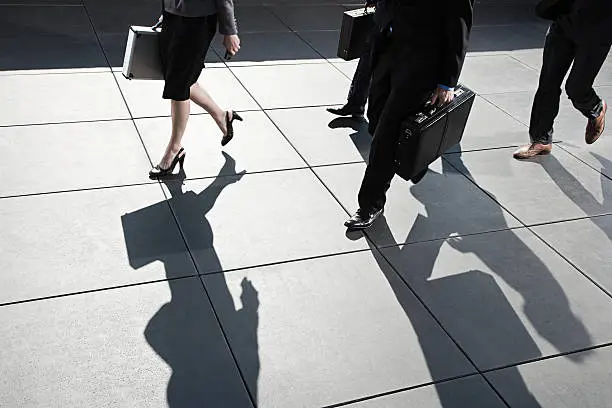 Photo of Businesspeople walking