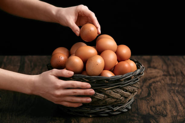 istock taking an egg out of a basket full of eggs 939076630