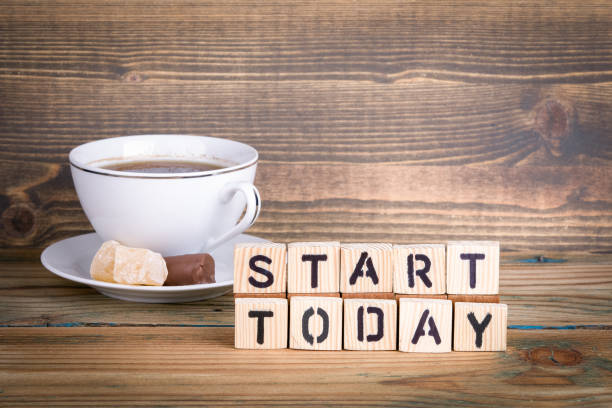 istock start today. Wooden letters on the office desk 939079868