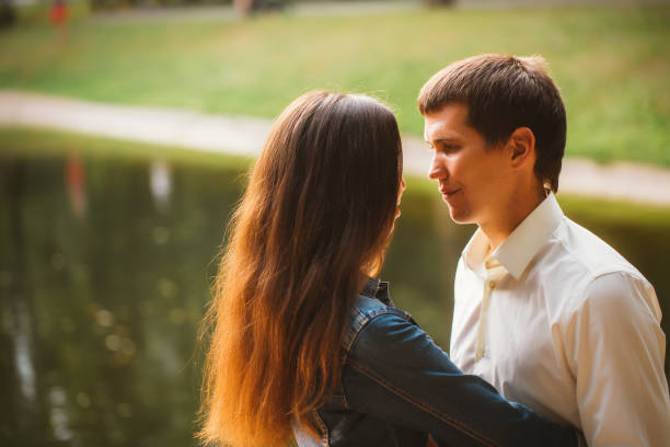 istock Beautiful young couple on the lake background 939084910