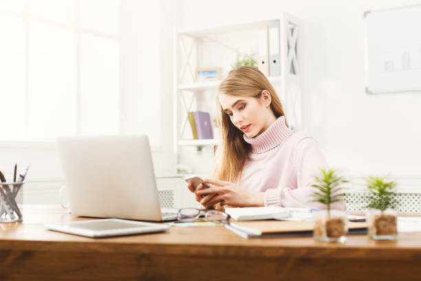 istock Young business woman working on phone 939085166