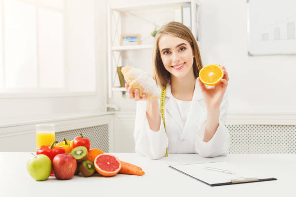 istock Dietitian nutritionist with bun and orange 939085272