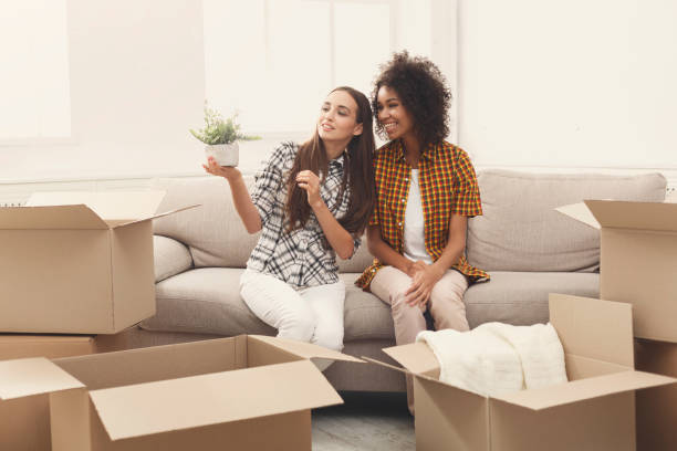 istock Two young women unpacking moving boxes 939086454