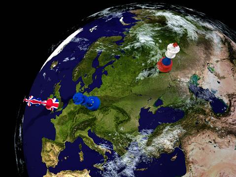 Render of a globe of the earth with chess pieces decorated with the British, Russian and European flags.\nThe Earth map is a public domain image from NASA's Visible Earth project: https://visibleearth.nasa.gov/view.php?id=73884