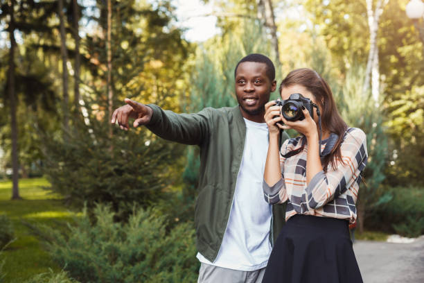 istock Man teaching his girlfriend photography 939103618