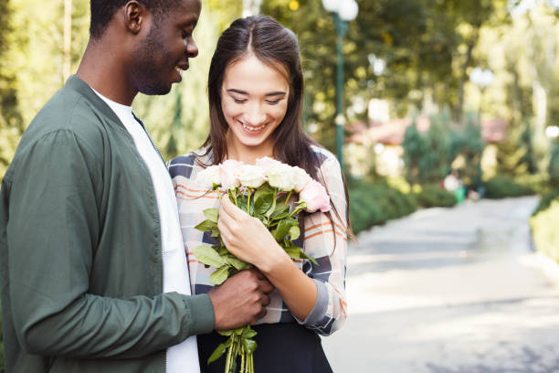 istock Man giving flowers for his beautiful girlfriend 939103946